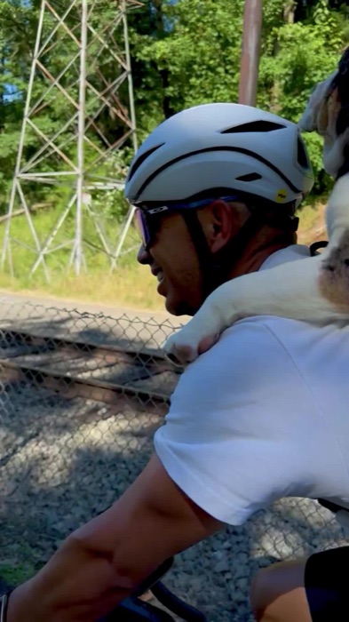 Ricky riding with his dog on his shoulders during an afternoon ride in Portland, OR